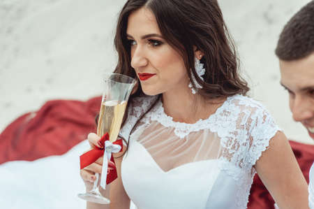 Happy smiling newlyweds drinking champagneの写真素材