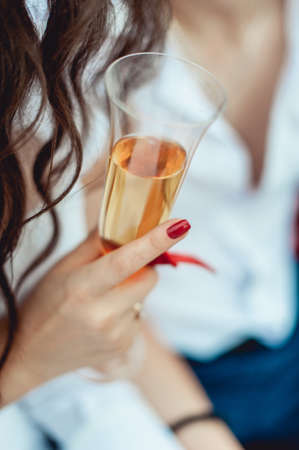 Bride and groom holding glasses in handsの写真素材