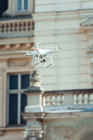 Drone quad copter flying at the building backgroundの写真素材