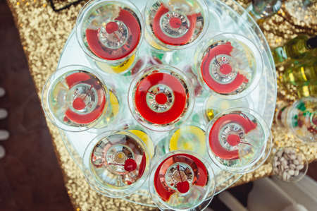 Cold alcoholic margareta cocktail. Glass with drink stands on the glass standの写真素材