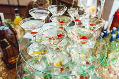 Cold alcoholic margareta cocktail. Glass with drink stands on the glass standの写真素材