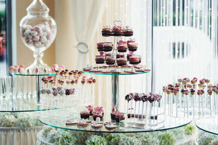 Cute candy bar with various candies and cakes. Wedding candybarの写真素材