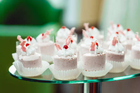 Pink craemy cakes on a stand. Close Upの写真素材