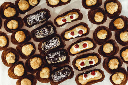 eclairs, traditional french dessert. white table