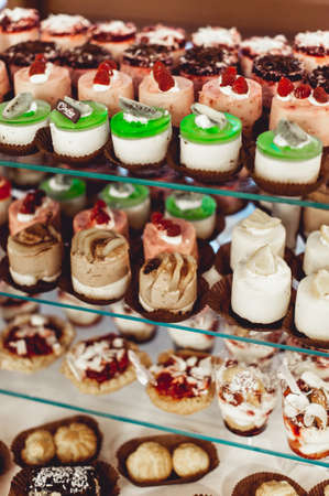 rows of italian mignon cakes on a glass stand