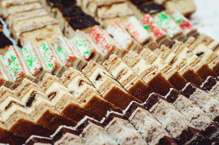 Rows of different dessert cakes on the wedding candy bar