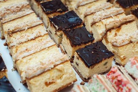 Rows of different dessert cakes on the wedding candy bar