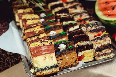 Rows of different dessert cakes on the candy barの写真素材