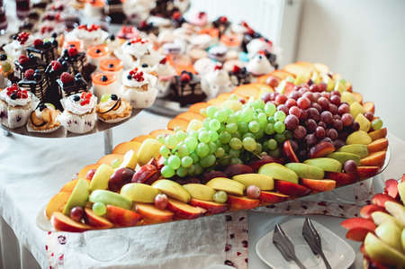 sliced fruits on a stand on a white table