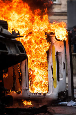burning car. car destroyed and set on fire during the riots. city centerの写真素材