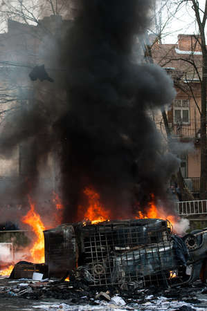 burning car. car destroyed and set on fire during the riots. city centerの写真素材