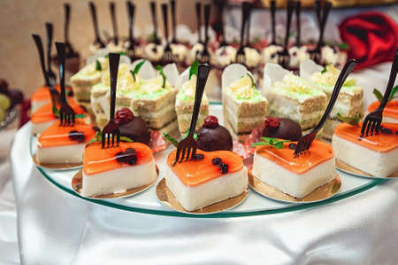 rows of italian cakes on a glass standの写真素材