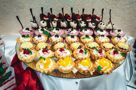 rows of different cakes on a glass stand