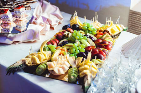 fresh sliced fruits on a glass standの写真素材