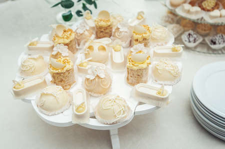 white Cakes and cupcakes on vintage white dishの写真素材