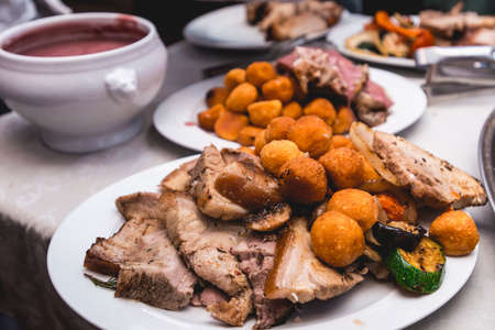 roasted meat with vegetables on a plateの写真素材