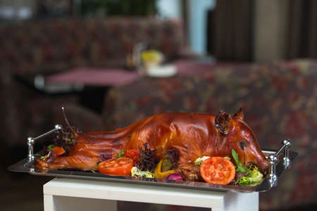roasted suckling pig with vegetables. Brunch in a restaurantの写真素材