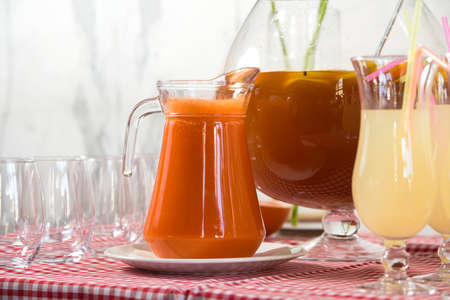Fresh juice on a table in a restaurant. Healthy drinks. carrot fresh in a jarの写真素材