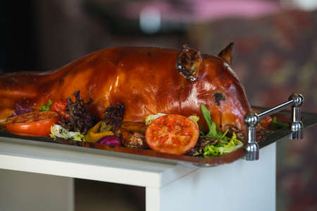 roasted suckling pig with vegetablesの写真素材