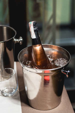Bottle of champagne in bucket in a restaurantの写真素材