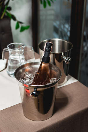 Bottle of champagne in bucket in a restaurantの写真素材