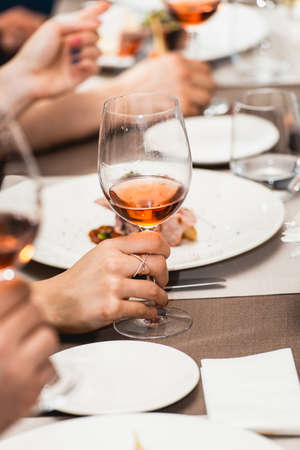 woman drinking wine on a wine tasting in a restaurant.