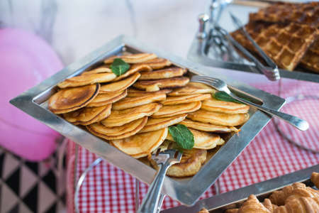 metal tray full of pancakes, brunch in a restaurantの写真素材