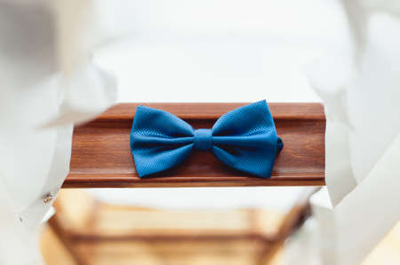 Blue bow tie on a wooden plank. Accessory for formal dress. Symbol of elegance and fashion for men.の写真素材