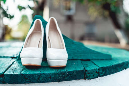 brides biege shoes on heel on a wooden board turquoise blue colourの写真素材