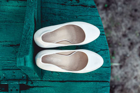 brides biege shoes on heel on a wooden board tiffany colour