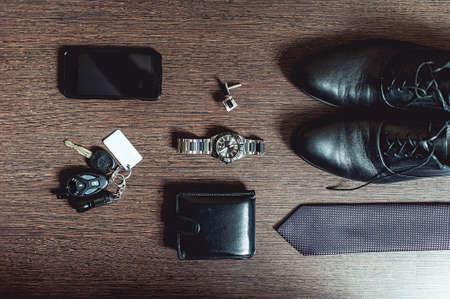 Accessories grooms wedding day. Wallet watch cufflinks tie shoes mobile phone car keysの写真素材