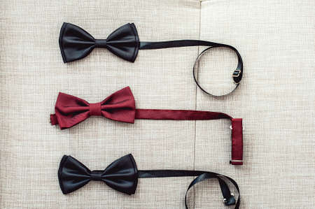 Three bow ties, two black and one red. Team work, career, hipster, wedding concept.の写真素材