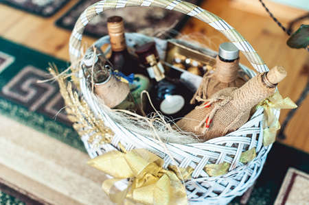 Wine bottles in a basket on a floorの写真素材