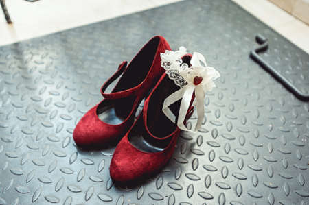 Ladies red chamois leather pumps shoes on a metal background, close upの写真素材