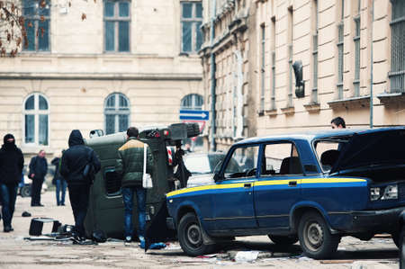cars destroyed by protesters during riot. Two police cars destroyed near police department, city centerの写真素材