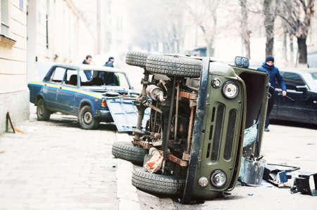 cars destroyed by protesters during riot. Two police cars destroyed near police department, city centerの写真素材