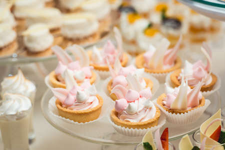 glass stand with cupcakes on a wedding candy bar table.の写真素材