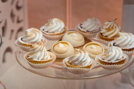 glass stand with cupcakes on a wedding candy bar table.の写真素材