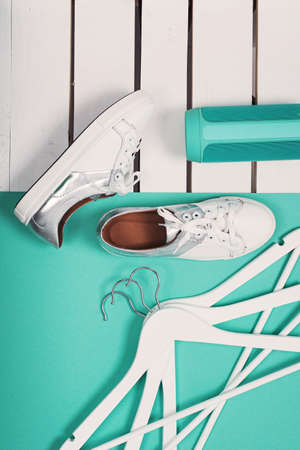 Flat Lay of Modern White Shoes. Overhead Top View Photography. Youth Lifestyle Concept. Turquoise backgroundの写真素材