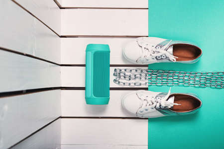 Flat Lay of Modern Womans Sport White Shoes. Overhead Top View Photography. Youth Lifestyle Concept. Square size. Turquoise backgroundの写真素材