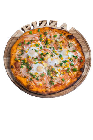Italian pizza with ham egg tomato and onion. A series of different types of pizza for menus photographed from one angleの写真素材