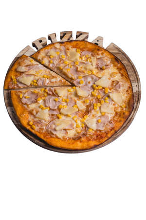 Italian pizza with ham pineapple and corn. A series of different types of pizza for menus photographed from one angle.の写真素材