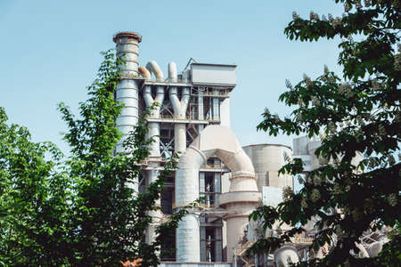Cement factory machinery on a clear blue skyの写真素材