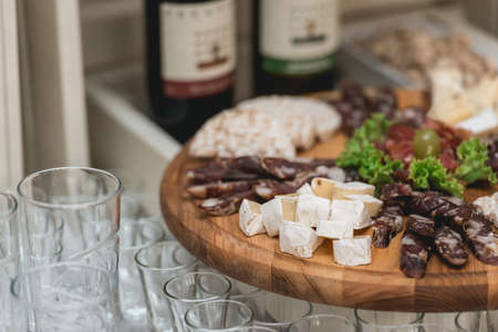 Mix cheese on wooden board with meat and bread in the restaurant