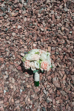 luxurious bridal bouquet of white peonies on a red chippingsの写真素材