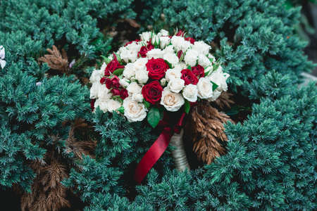 wedding bouquets of biege and red rosesの写真素材