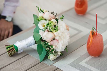 luxurious bridal bouquet of white peonies on a tableの写真素材