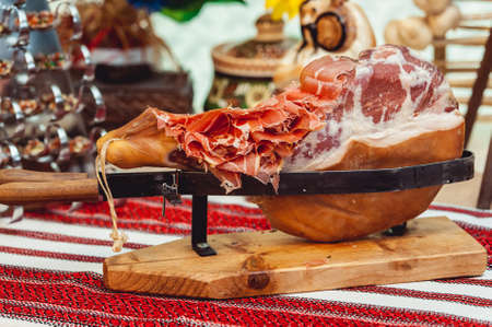 Prosciutto Ham served on a rustic wooden board with wine and thyme. Rustic Styleの写真素材
