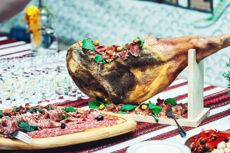Prosciutto Ham served on a rustic wooden board with wine and thyme. Rustic Styleの写真素材