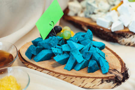 tinned blue cheese on a wooden boardの写真素材